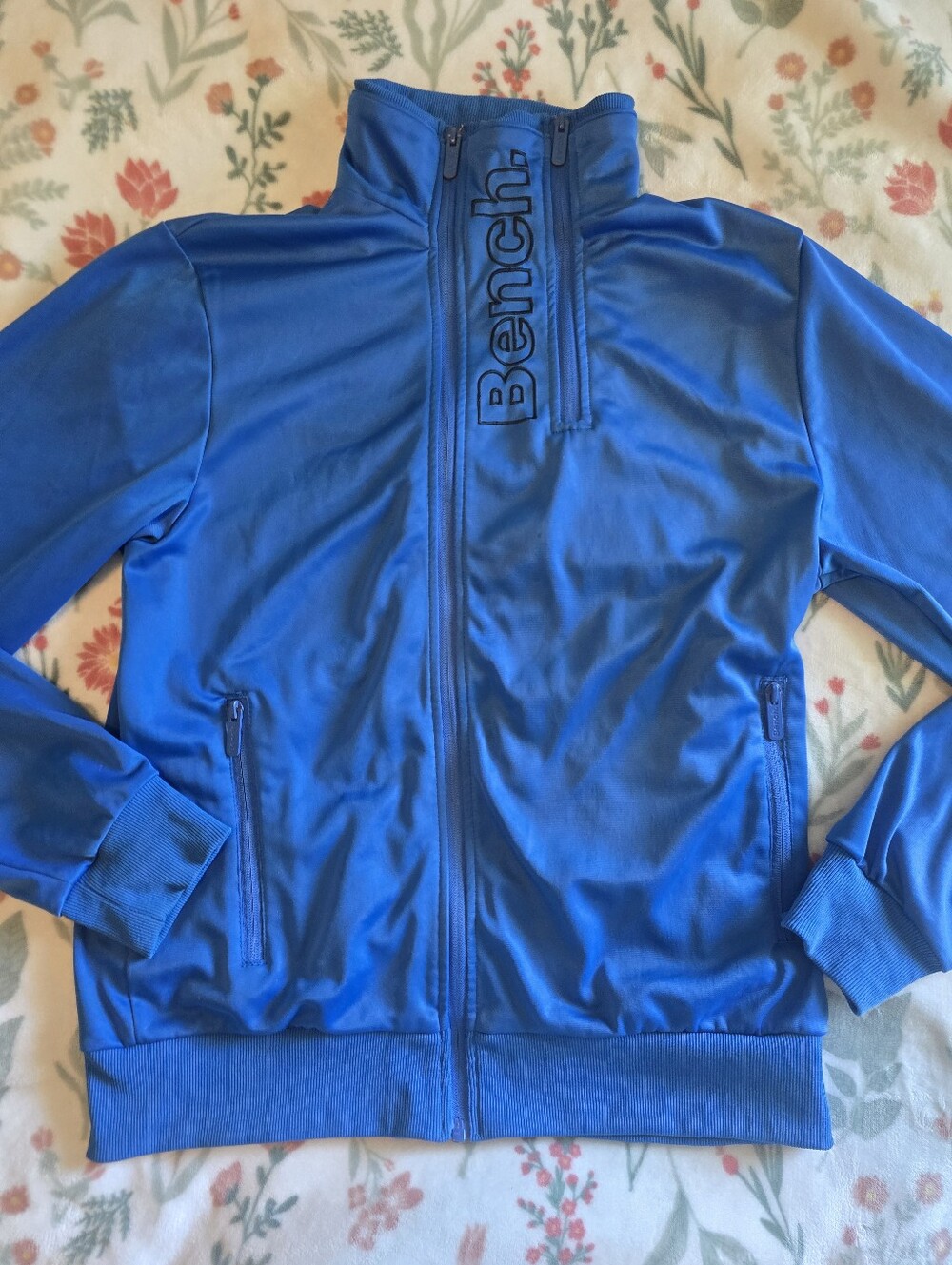 Vibrant blue Bench track jacket featuring a distinct vertical logo printed down